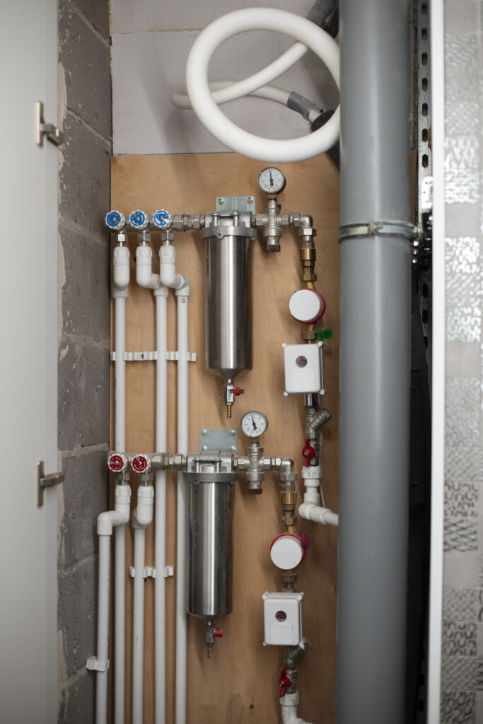 Exposed plumbing pipes and system panel